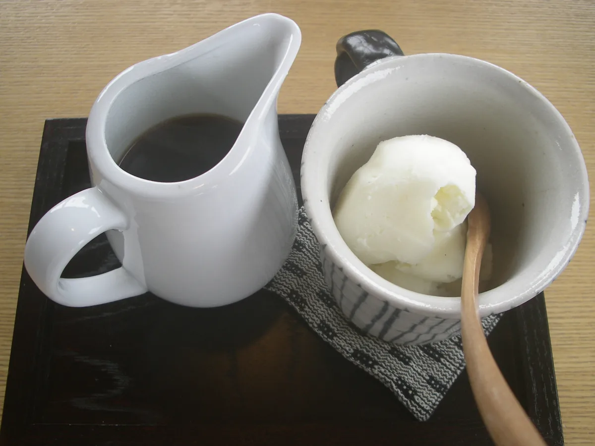 Vanilla ice cream in a bowl with a jug of coffee alongside, ready to pour